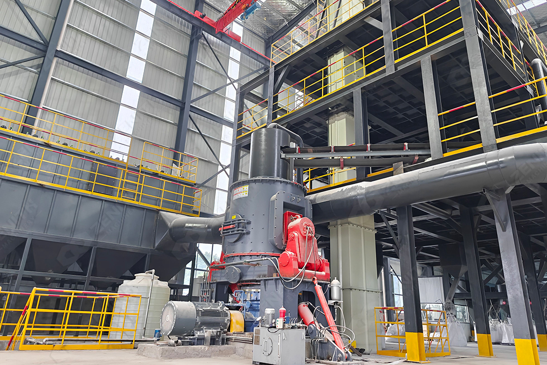 Operator monitoring a modern touch-screen control panel for a vertical grinding mill system, displaying real-time production data.
